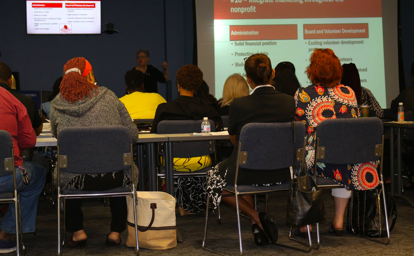 Presenter speaking to attendees at the summit